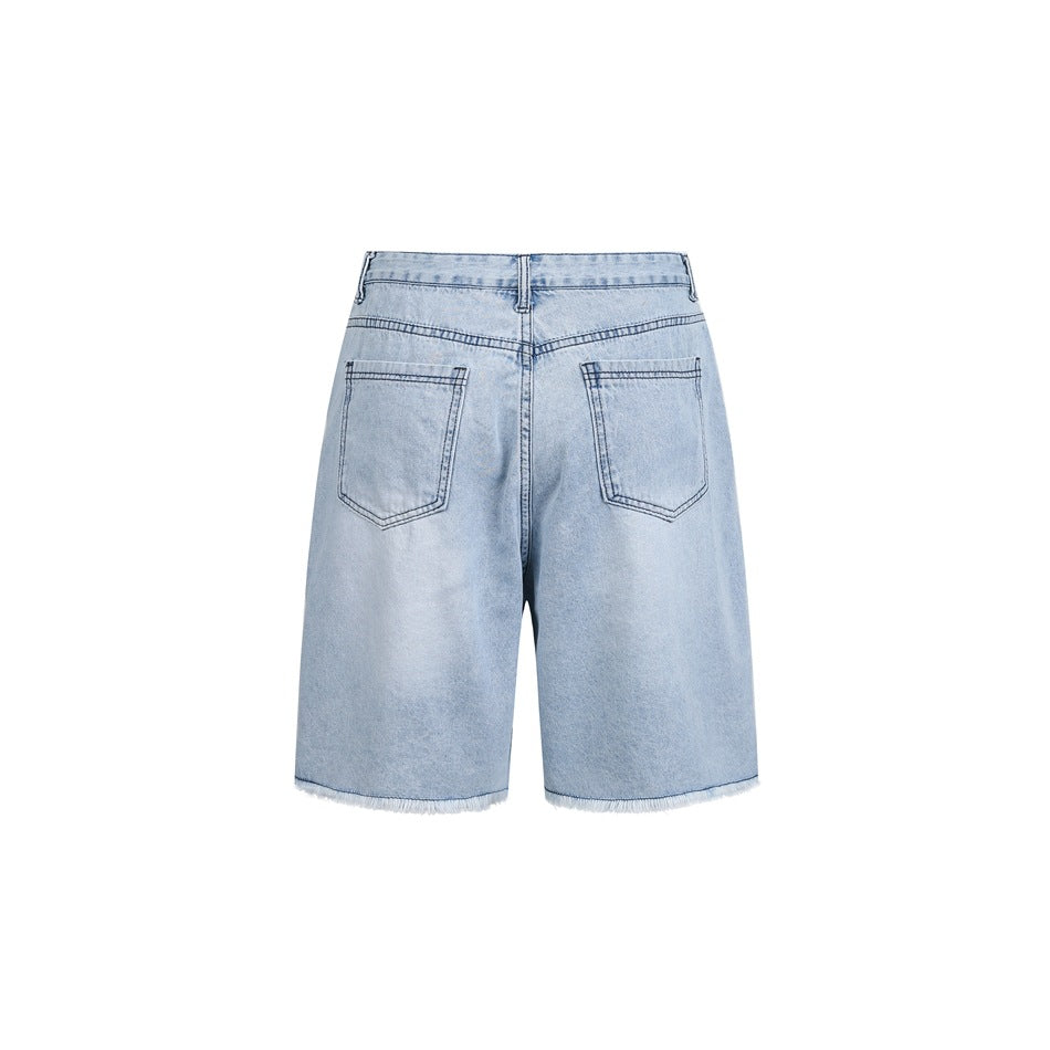 Back view of light-wash denim shorts with two patch pockets and frayed hems.