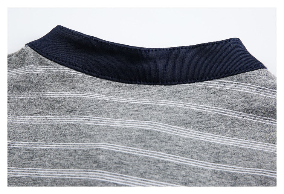 Close-up of a navy ribbed collar on a gray garment with thin white stripes.