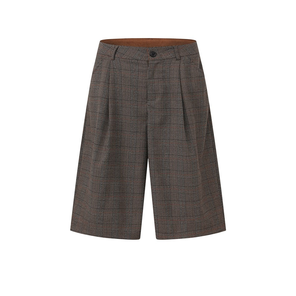 Brown plaid knee-length shorts with front pleats, button waistband and belt loops on a white background