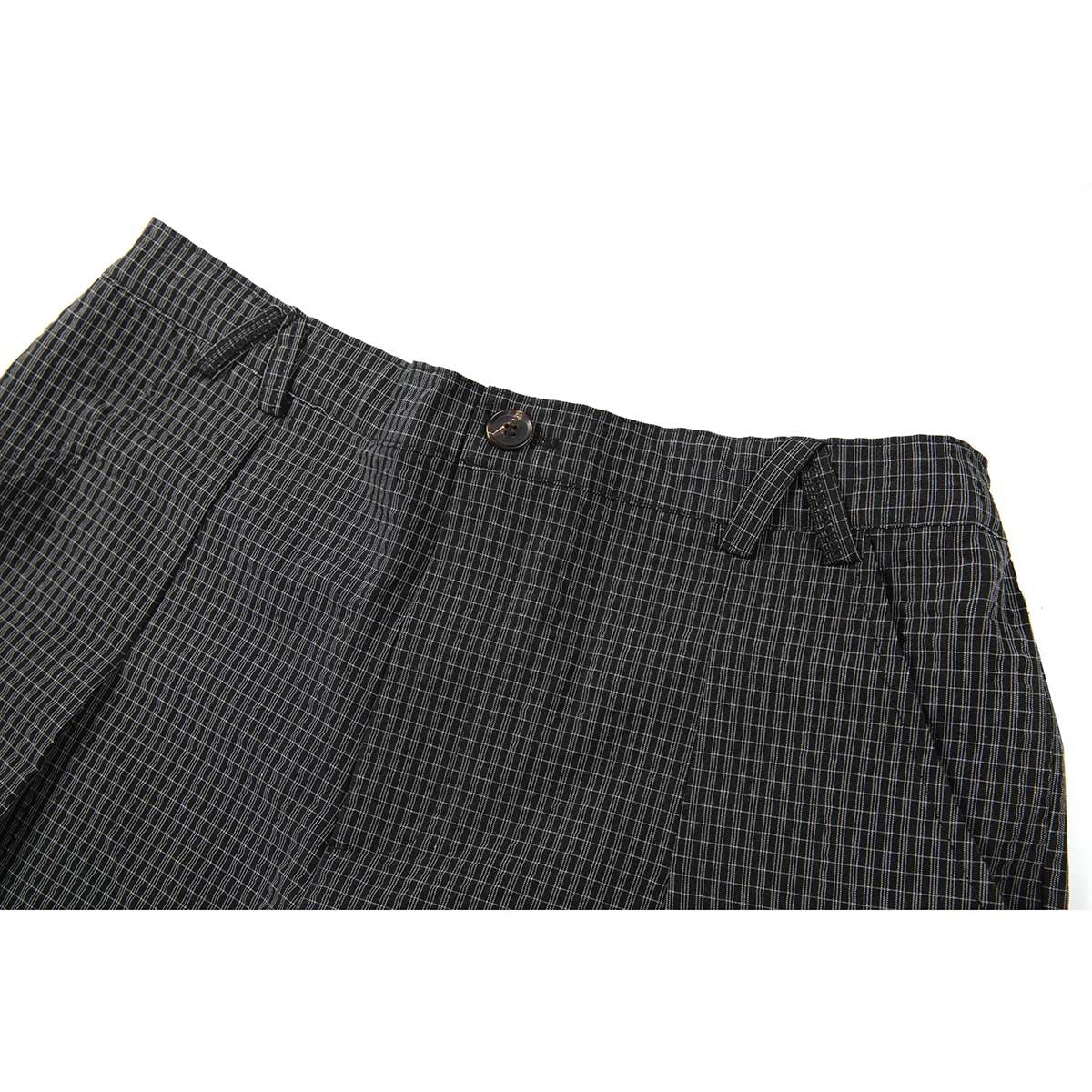 Close-up of dark charcoal plaid shorts showing the waistband, button, belt loops and front pleats.