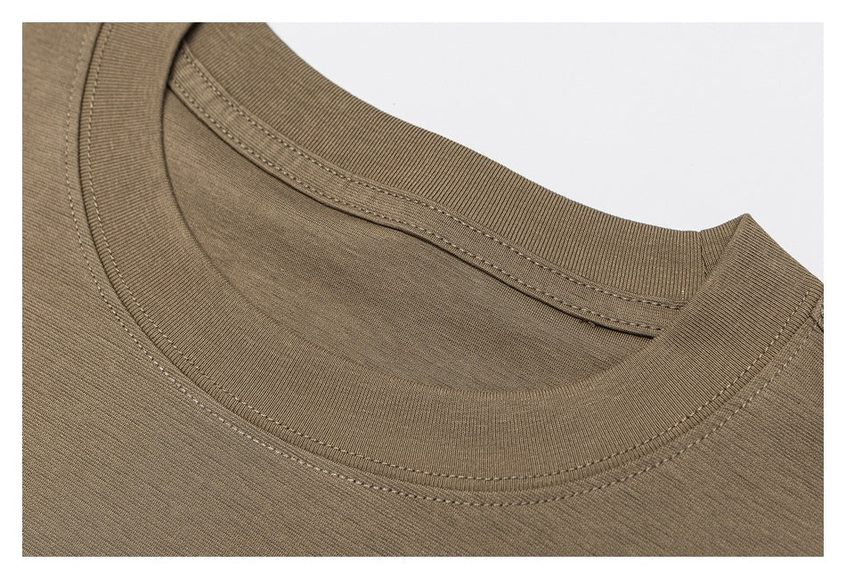 Close-up of a taupe crew neckline with ribbed trim and double-stitched seams.