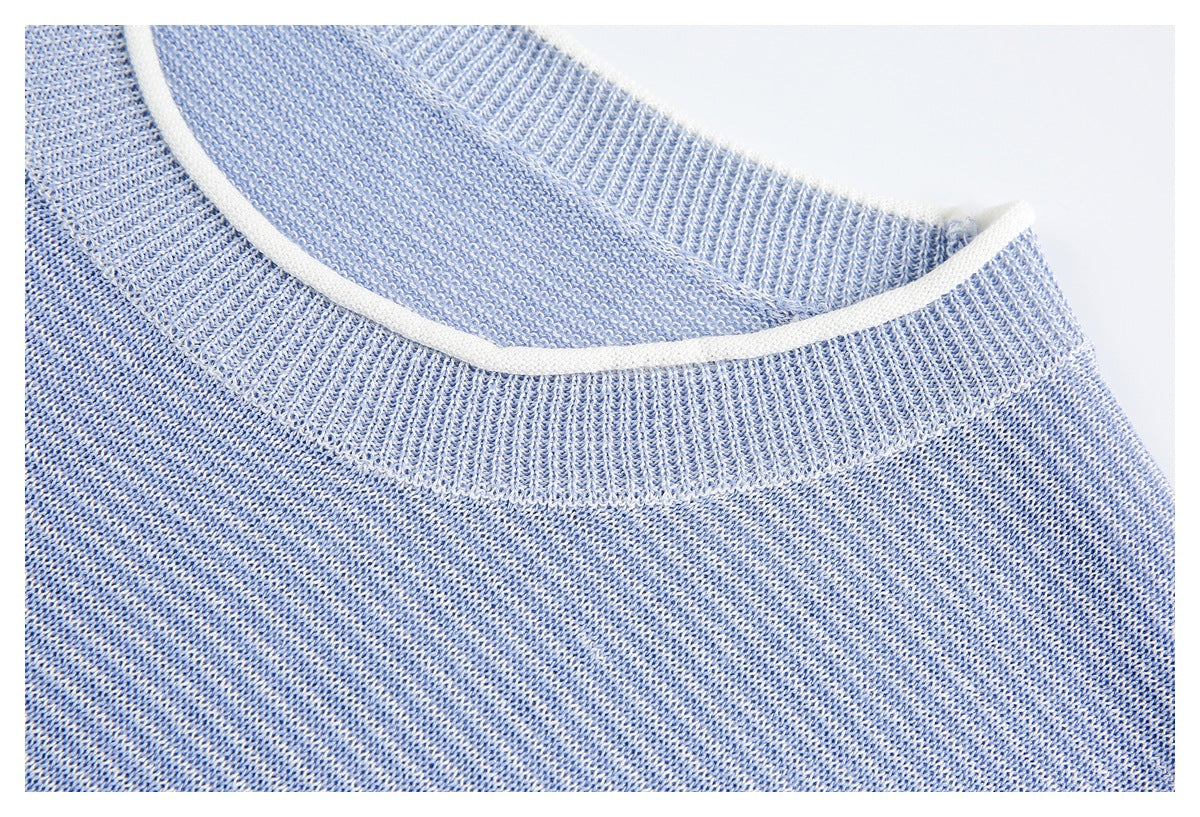 Close-up of a light blue knit sweater's ribbed neckline with white trim.