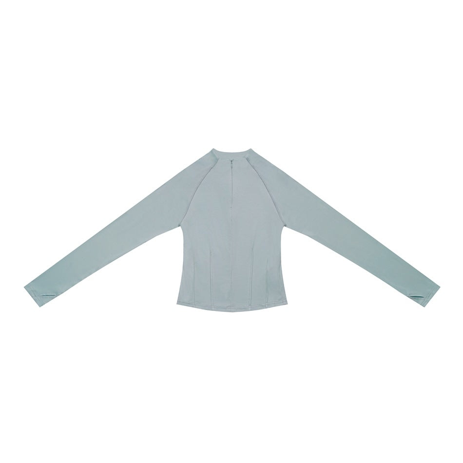 Light blue long-sleeve half-zip top laid flat with raglan sleeves and thumbholes