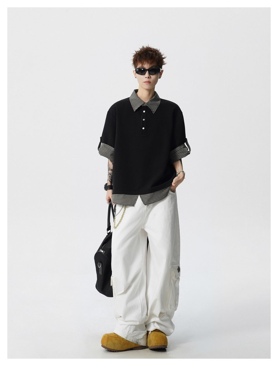 Full-length view of model in black gingham-trim polo-style top, white cargo pants and yellow shoes holding a bag