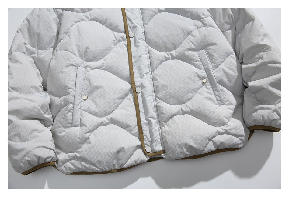 Cropped front view of a light gray quilted jacket with brown trim, snap closure, and two angled pockets.