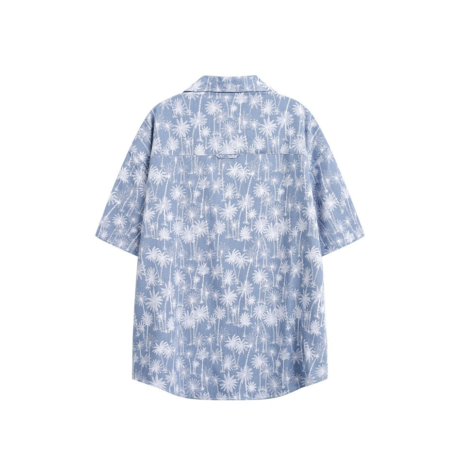 Back view of light blue short-sleeve shirt with white palm tree print and back yoke seam