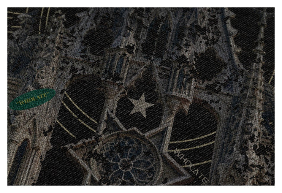 Close-up of the castle graphic, showing a star and small decorative lettering on black fabric.