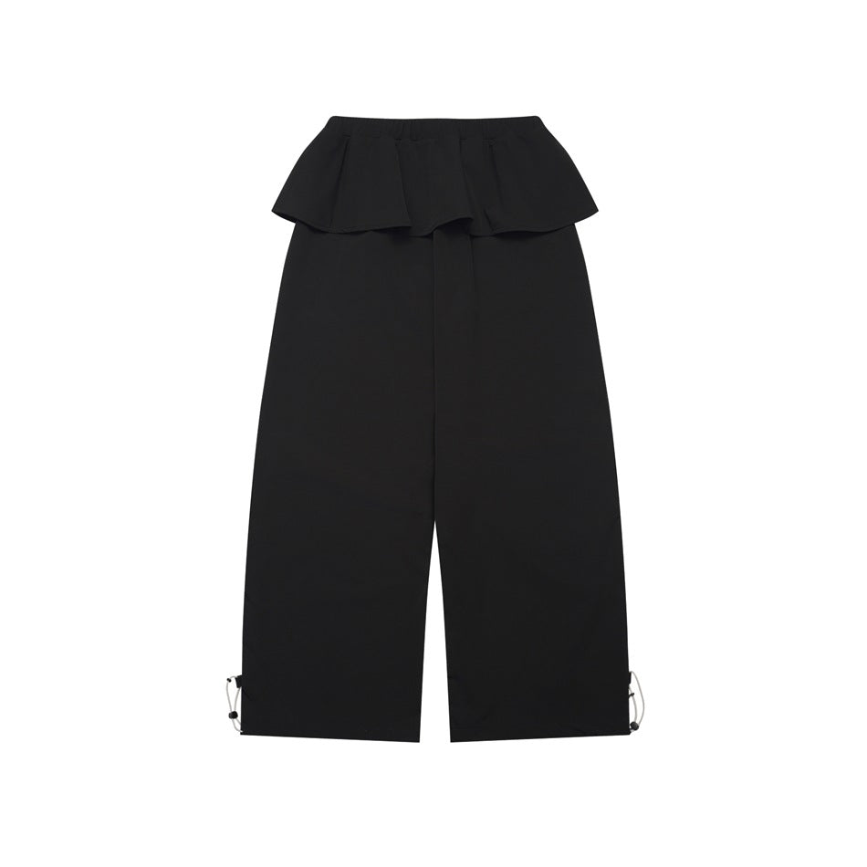 Black wide-leg pants with a layered ruffle waistband and adjustable drawcords at the hems, shown flat on white.