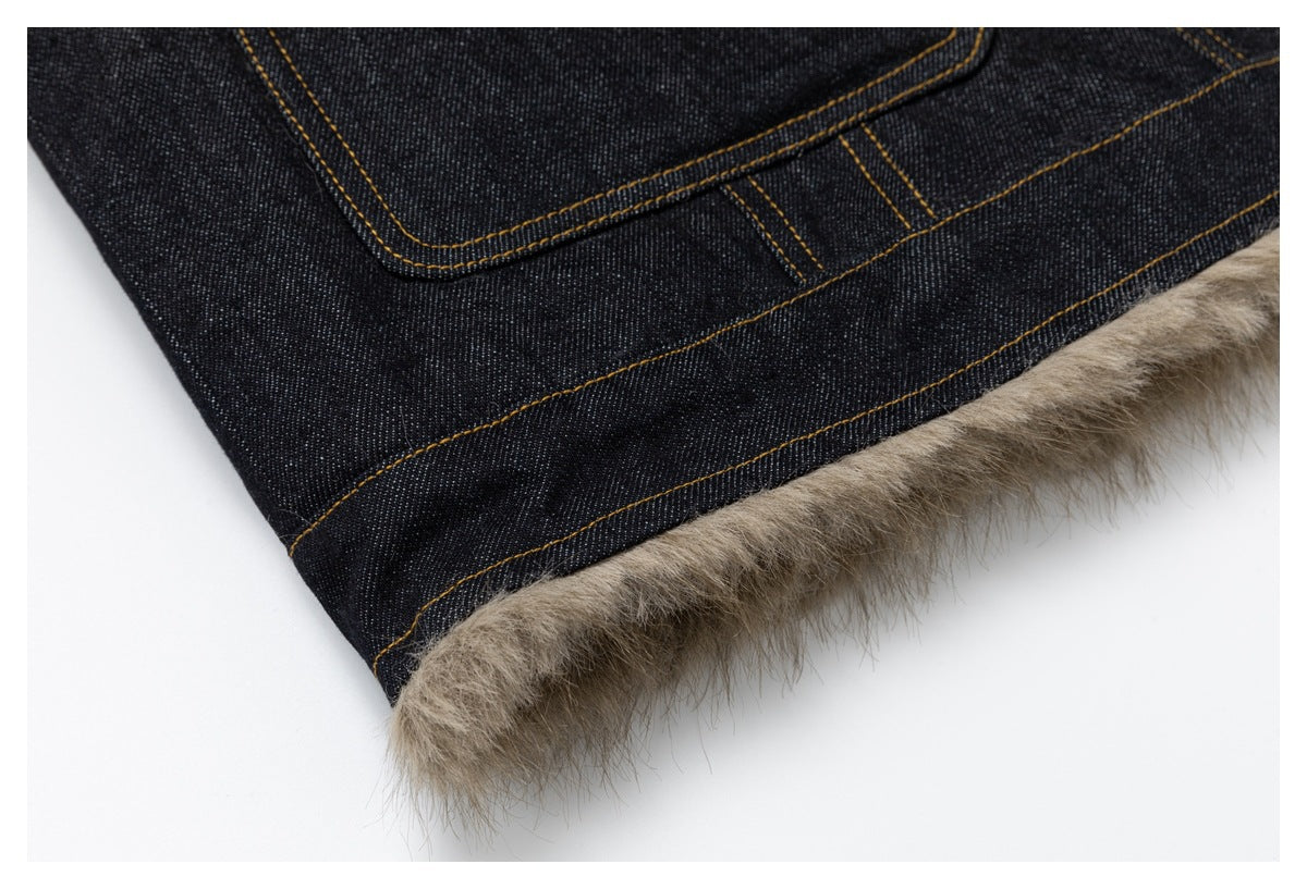 Close-up of the dark denim hem with tan stitching and taupe fluffy trim.