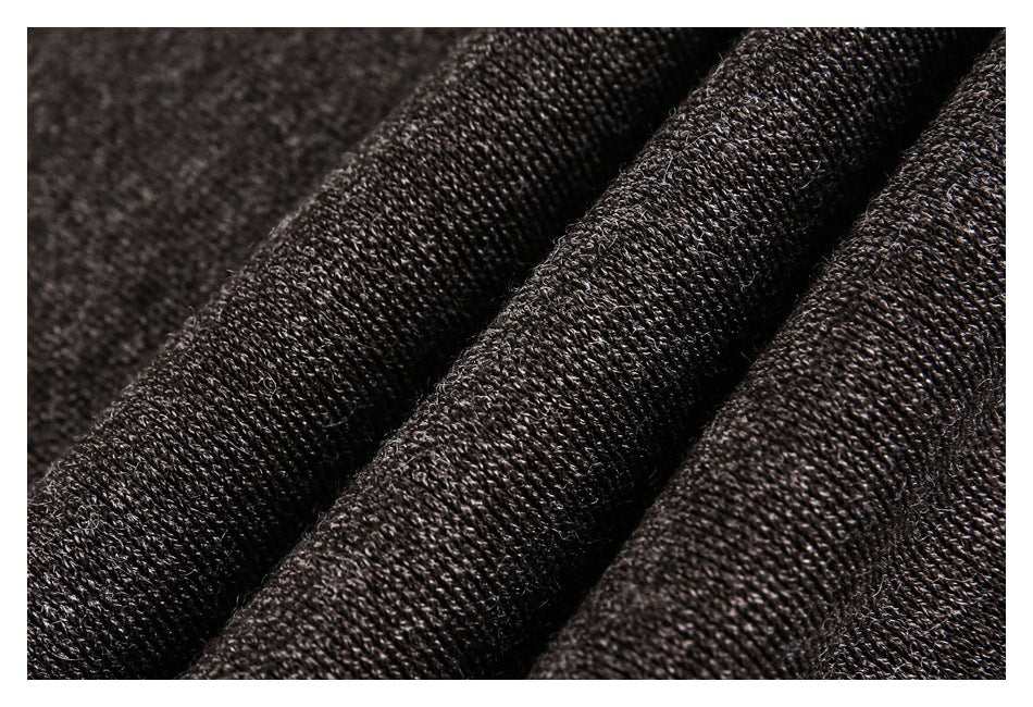 Close-up of dark charcoal-brown knit fabric with a visible textured weave.