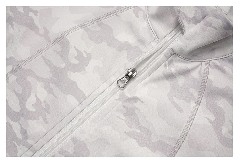 Close-up of the front zipper pull and seam detailing on a light gray camouflage top.