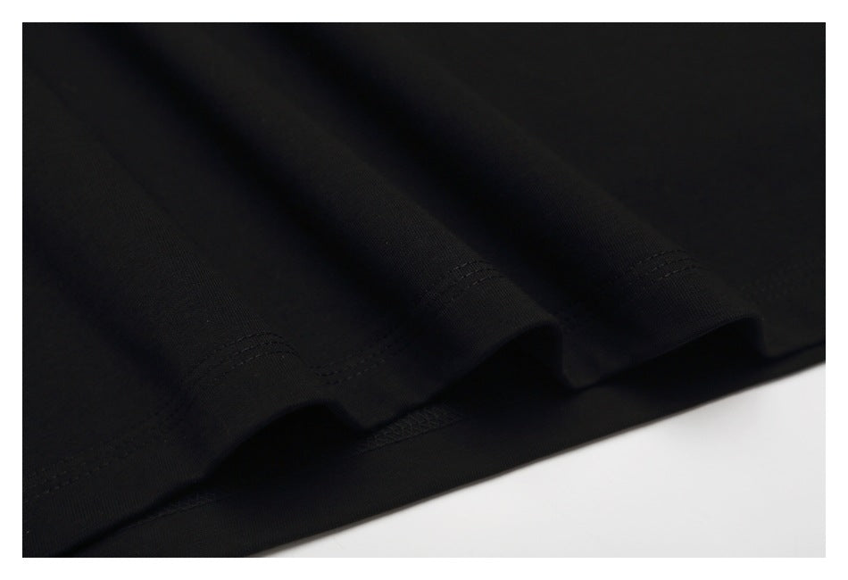 Close-up of the black T-shirt's folded hem with visible stitching.