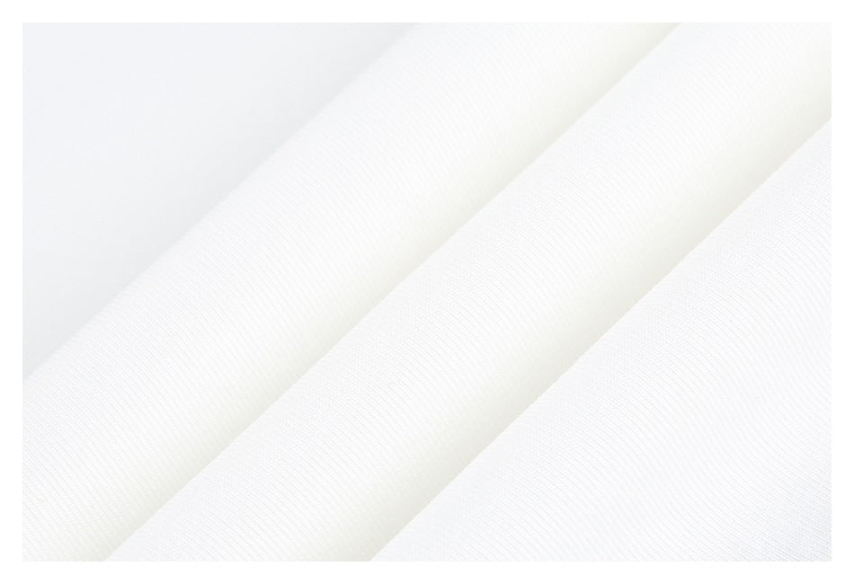 Close-up of white fabric showing a fine ribbed texture and soft folds.