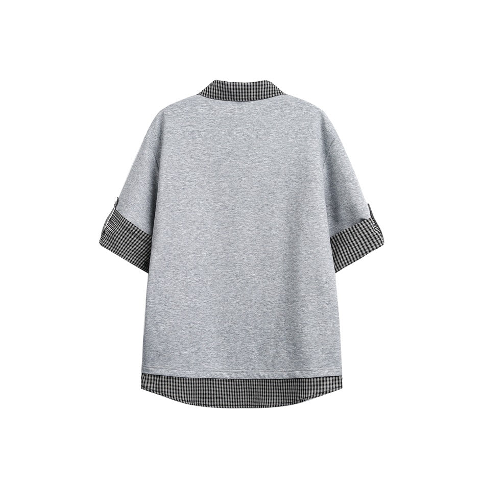 Back view of a gray oversized top with black-and-white checked collar, sleeve cuffs, and curved layered hem.