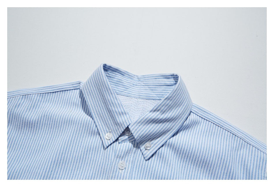 Close-up of a blue-and-white striped shirt collar with button-down points and front button.