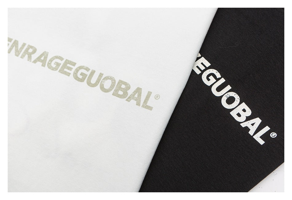 Close-up of white and black T-shirt fabric with large printed lettering.