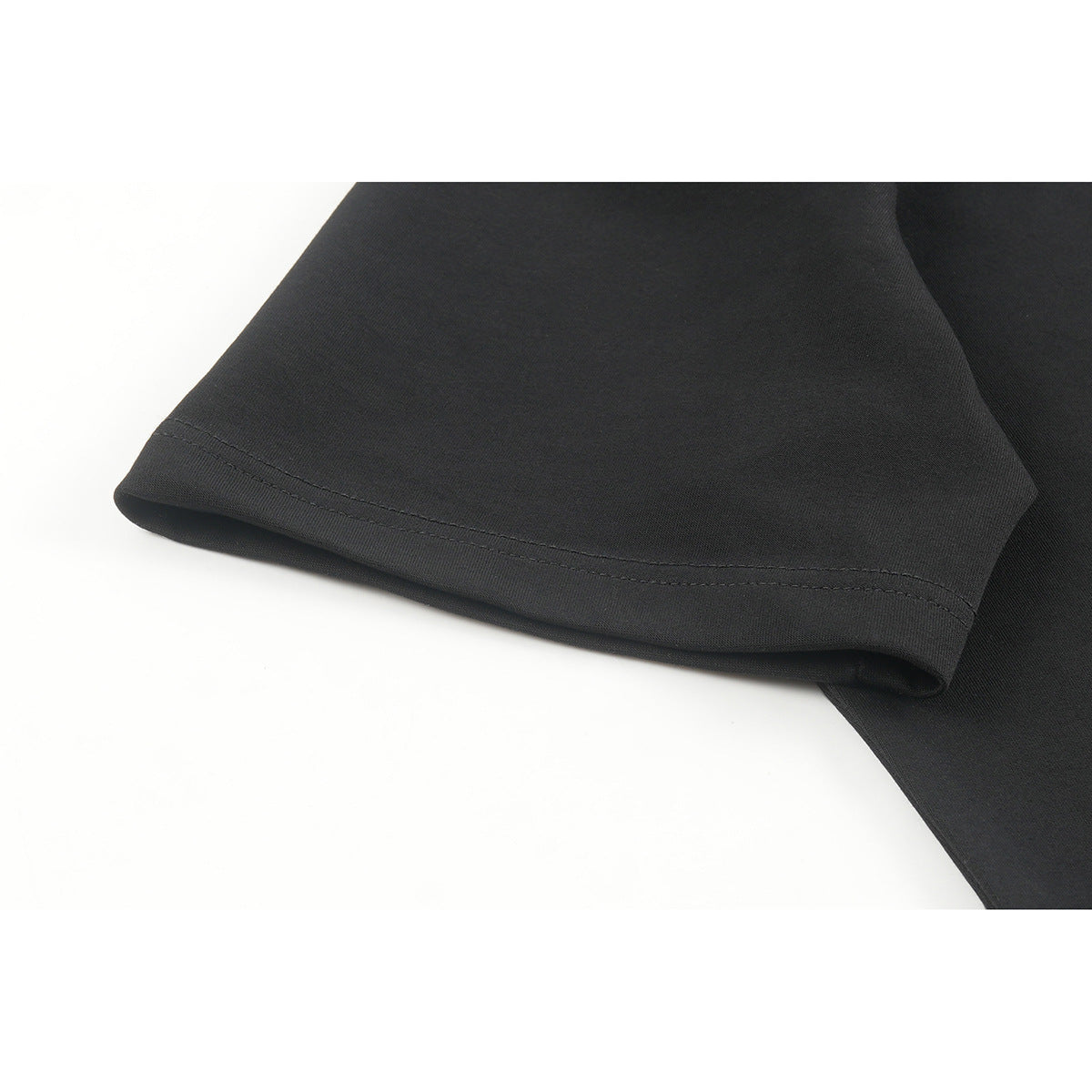 Close-up of a black T-shirt sleeve with a double-stitched hem.