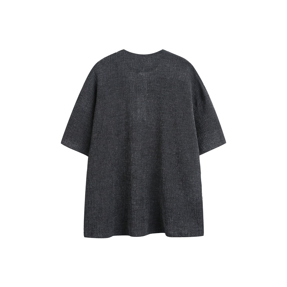 Back view of a boxy charcoal short-sleeve top with a round neckline and subtle textured pattern.