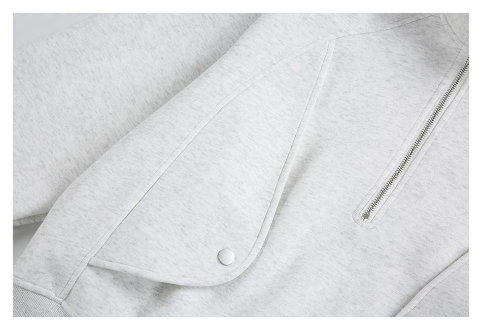 Close-up of the jacket's curved snap-flap pocket and narrow silver zipper pocket.