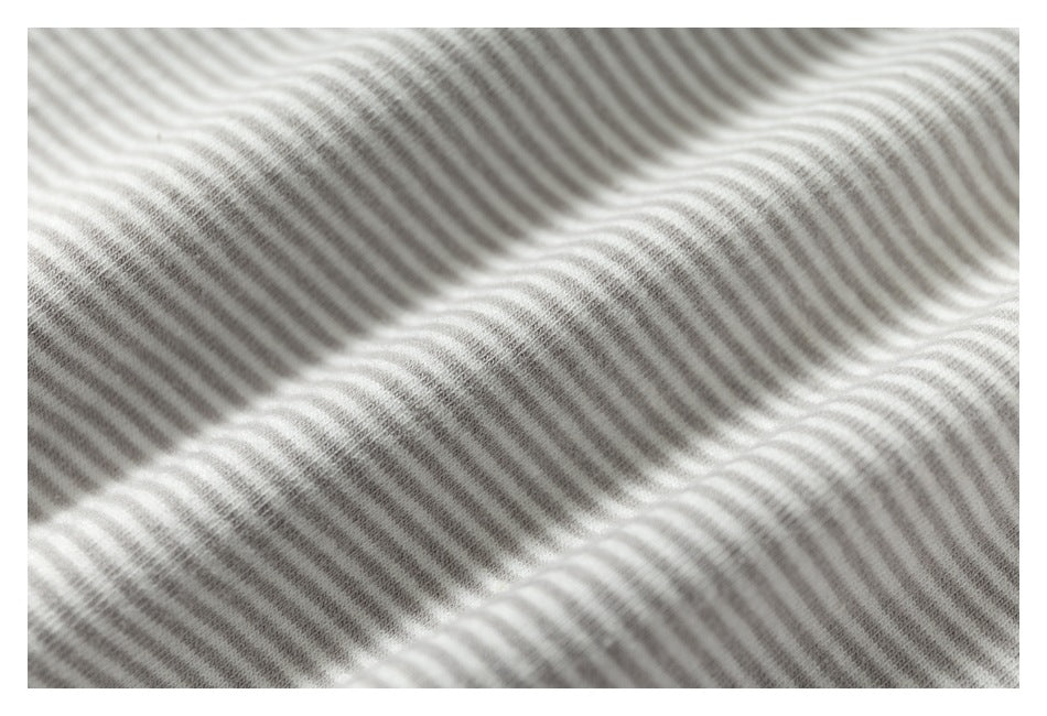Close-up of gray-and-white striped fabric draped in soft folds.