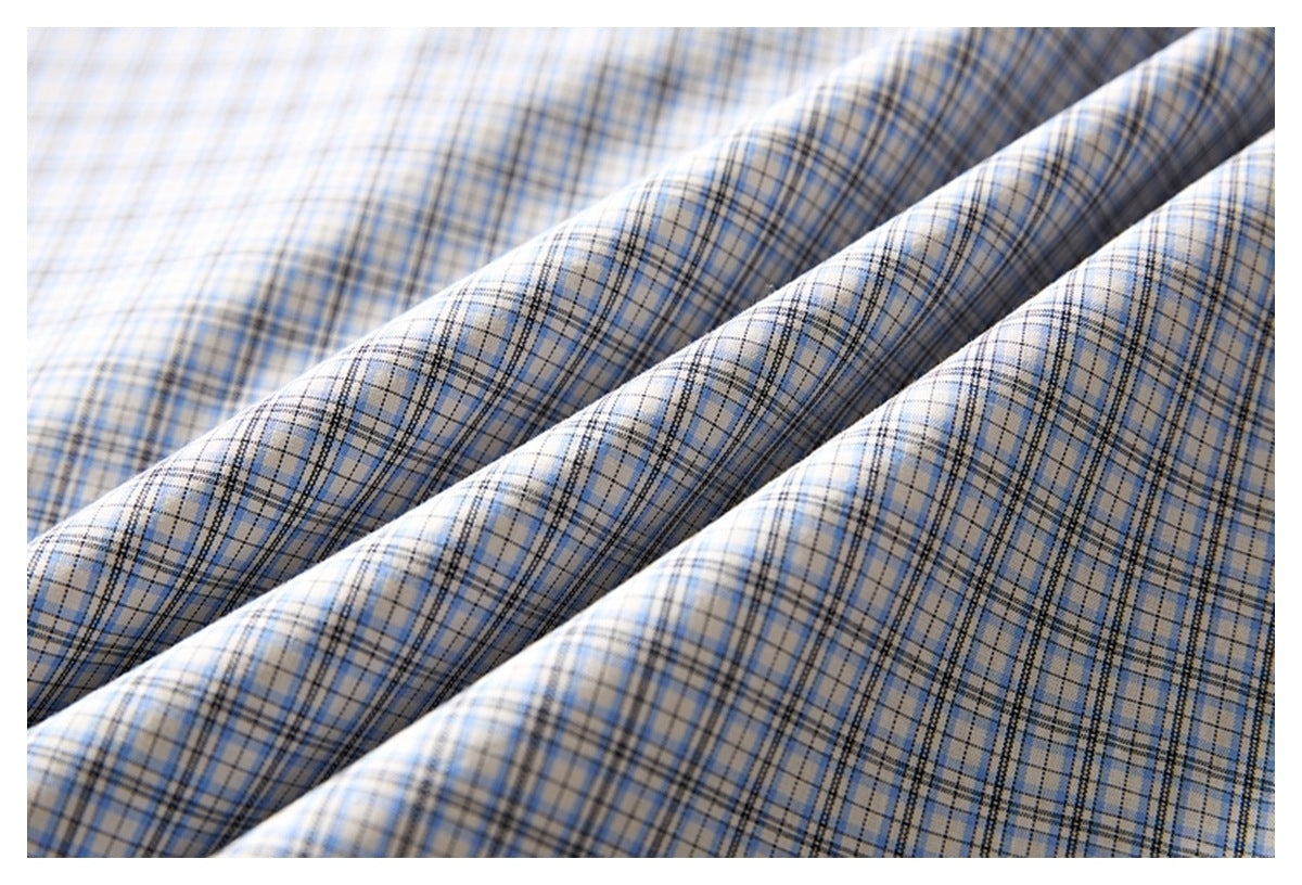 Close-up of the blue and gray plaid shirt fabric arranged in soft folds.