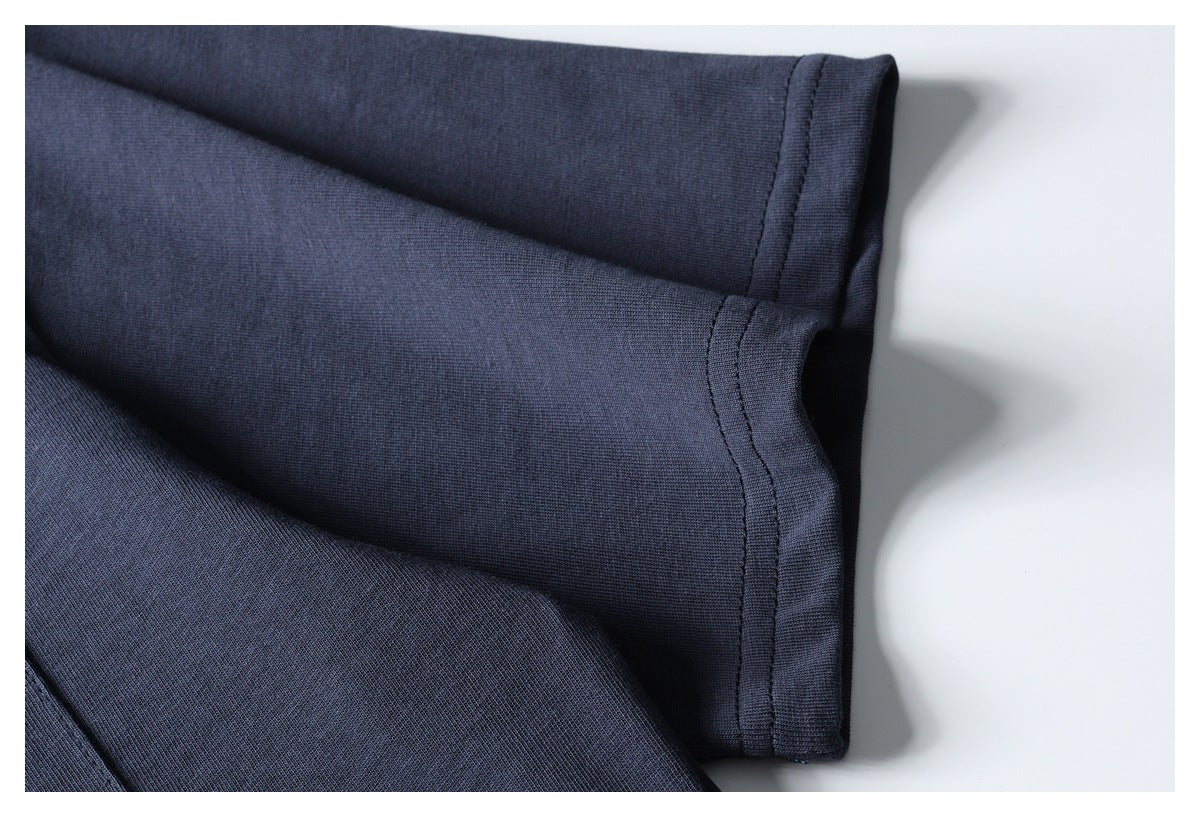 Close-up of a dark navy T-shirt sleeve and double-stitched hem.