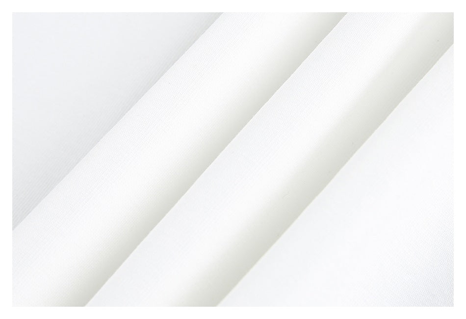 Close-up of white textured fabric arranged in soft diagonal folds.