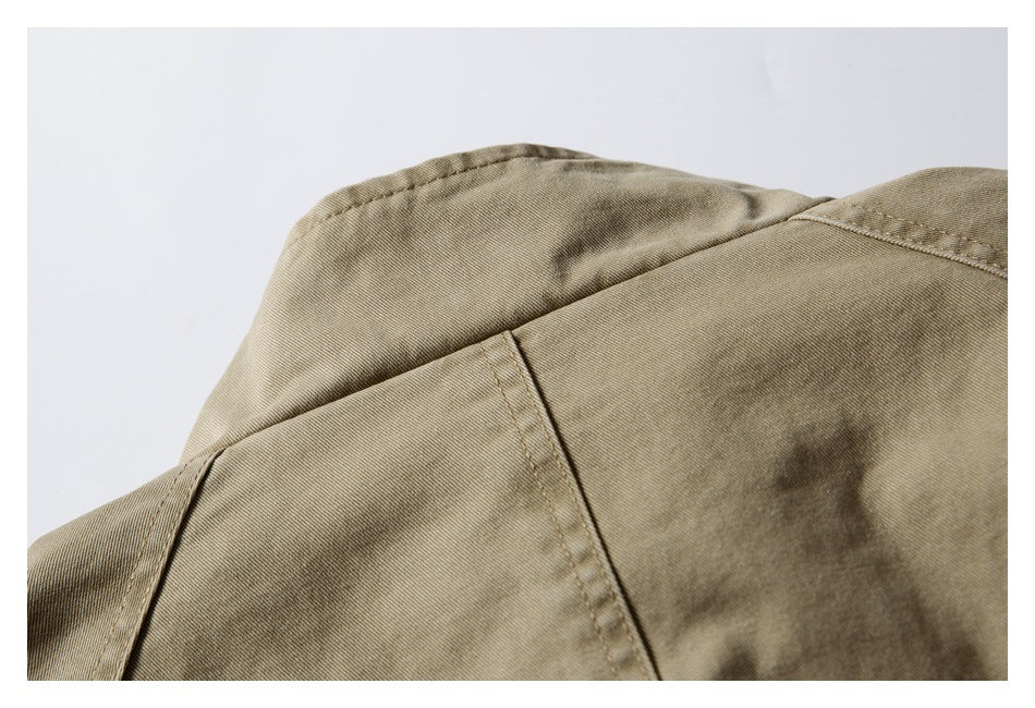 Close-up of the khaki garment's shoulder and collar seams.
