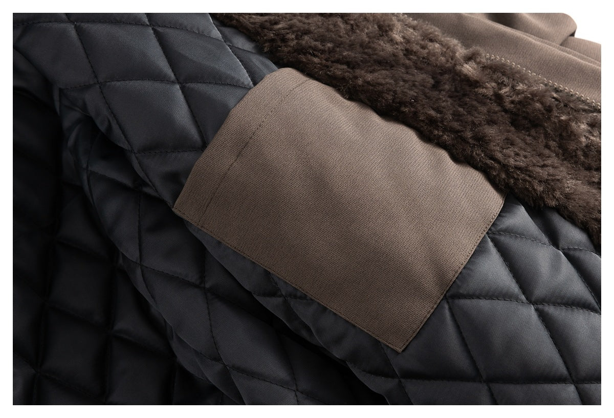 Close-up of a dark quilted garment with a brown fabric panel and plush brown trim.