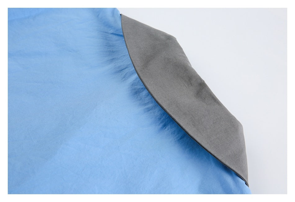 Close-up showing light blue garment fabric beside a gray underside panel.