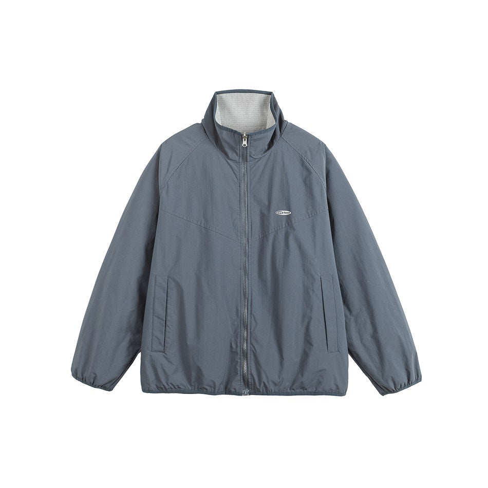 Front view of a dark gray zip-up jacket with a stand collar, long sleeves, and two front pockets.