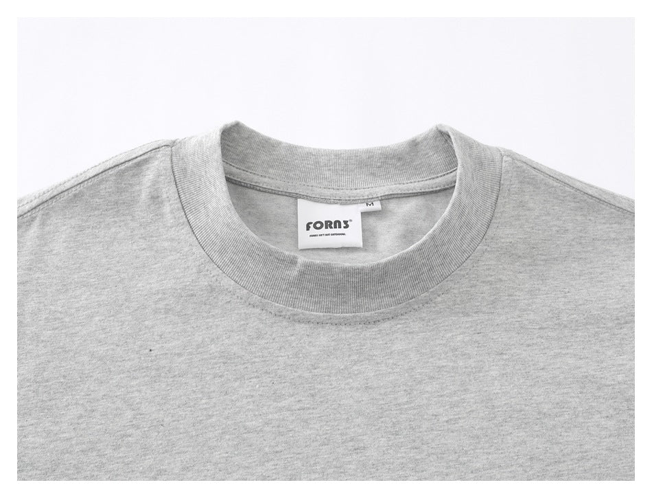Close-up of the gray T-shirt's ribbed crew neck and sewn-in collar label.