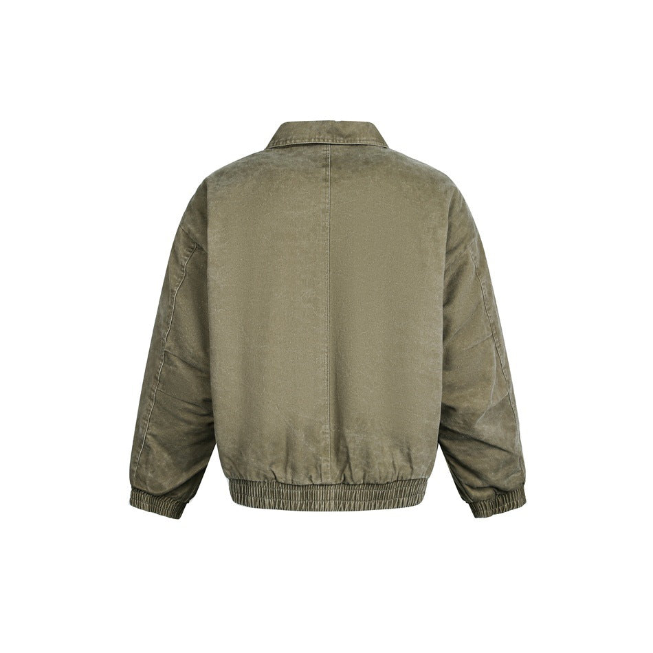 Rear view of an olive-brown jacket with a center seam, pointed collar, and elasticated cuffs and hem on white.