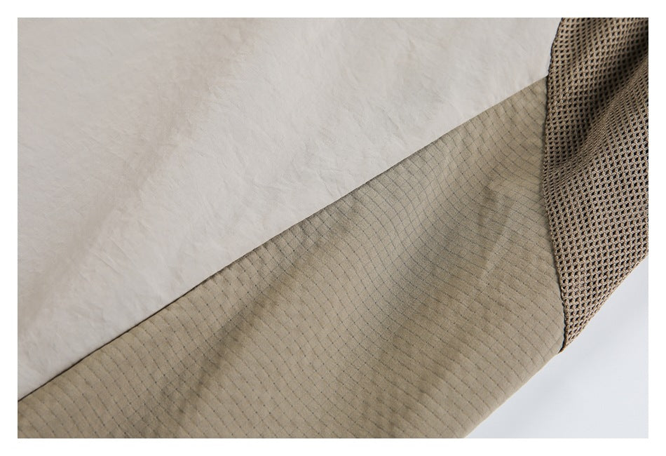Close-up of light beige garment fabric, a tan grid-textured panel, and a brown mesh section.