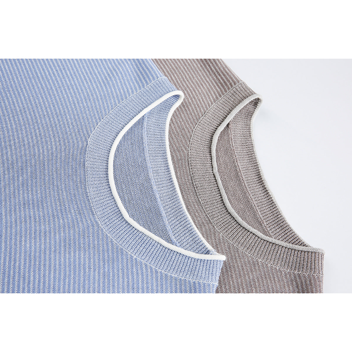Close-up of blue and taupe striped knit tops showing ribbed crew necks with white piping.