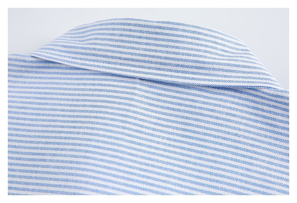 Close-up of a curved folded edge on blue-and-white striped fabric.