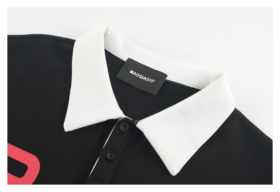 Close-up of the polo's white pointed collar, black placket and sewn brand label.