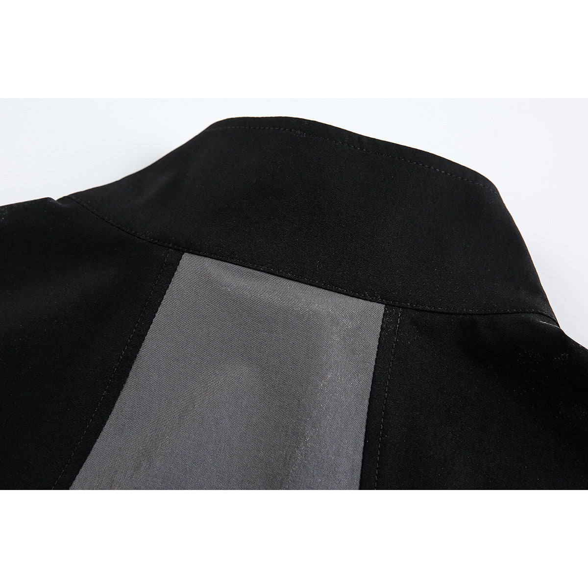 Close-up of the jacket's black back yoke and charcoal-gray center panel.