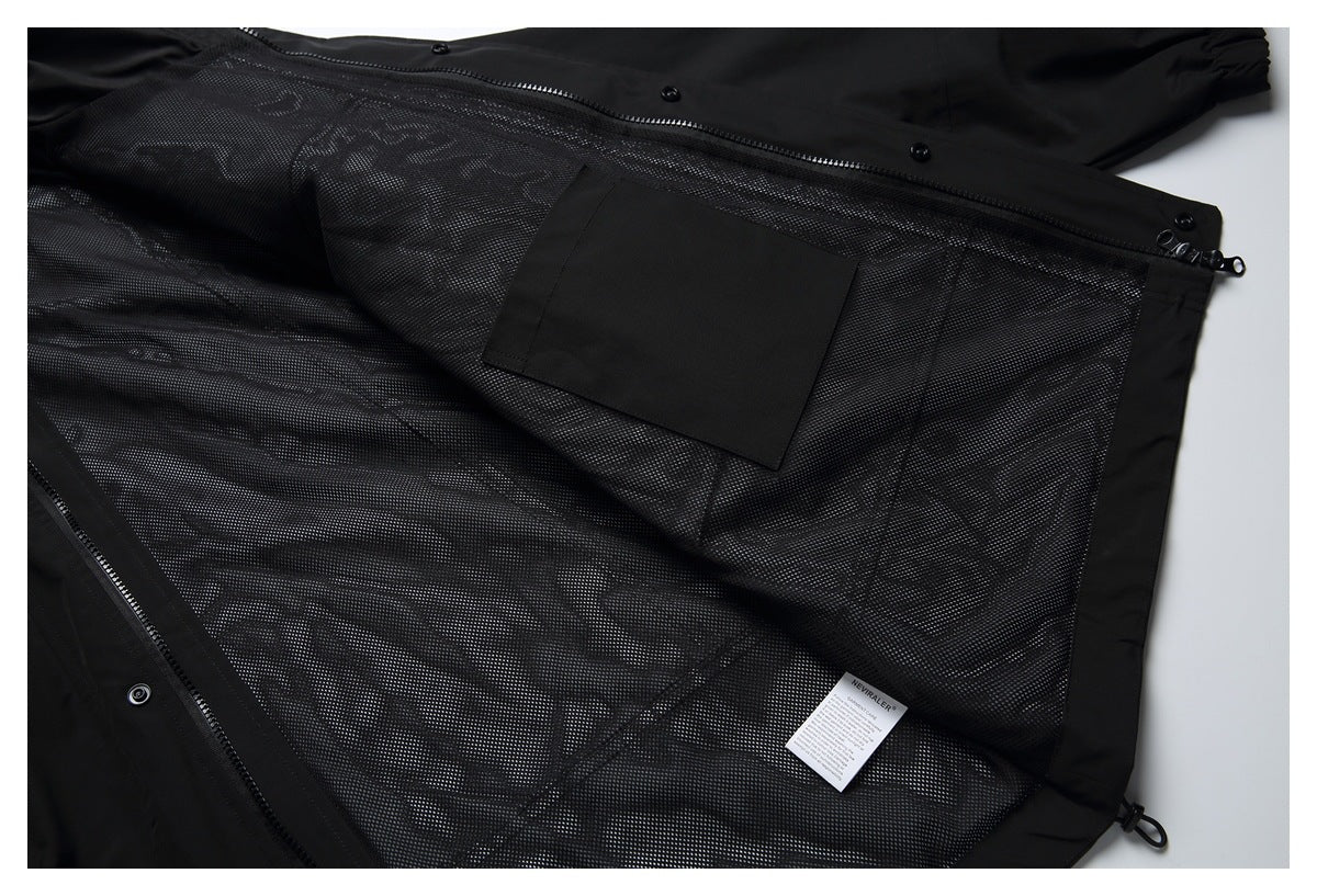 Black jacket opened flat to show its mesh lining, zipper, inner pocket, and sewn-in label.