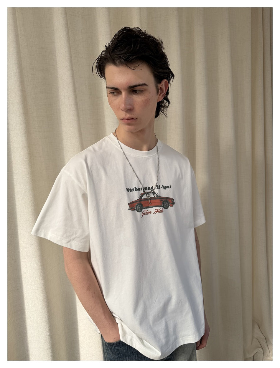 Model wearing a white T-shirt with a small red car graphic and English text on the chest.