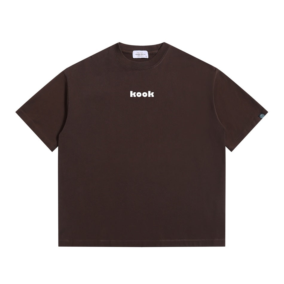 Brown short-sleeve crew-neck T-shirt with small white 'kook' print at center chest, flat front view