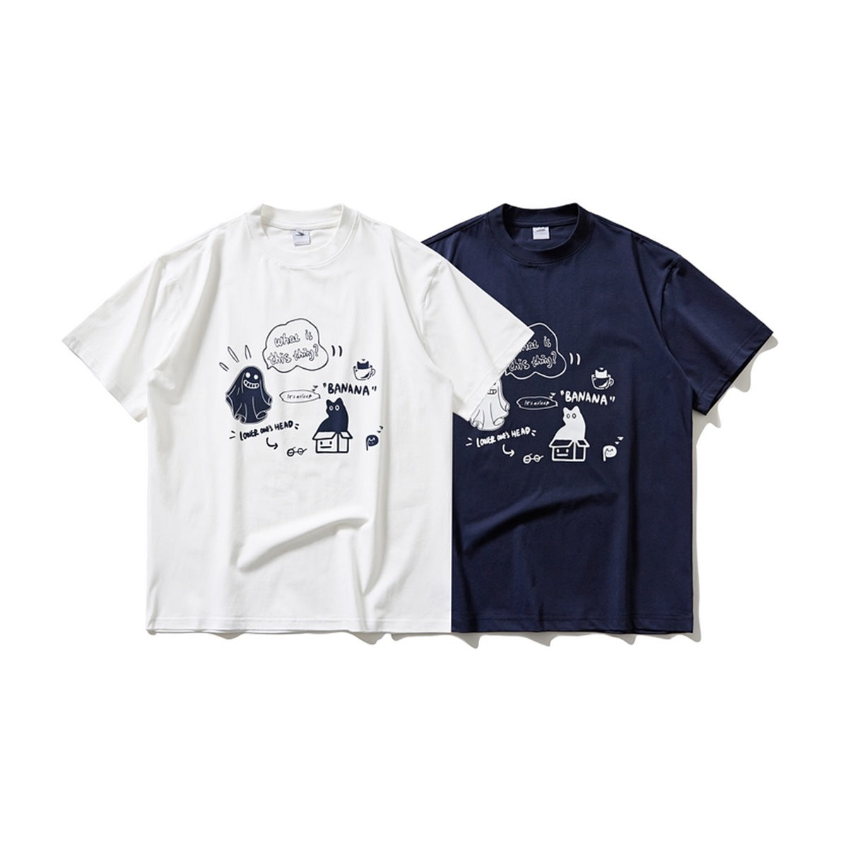 White and navy short-sleeve crew-neck T-shirts with matching cartoon prints, shown from the front.