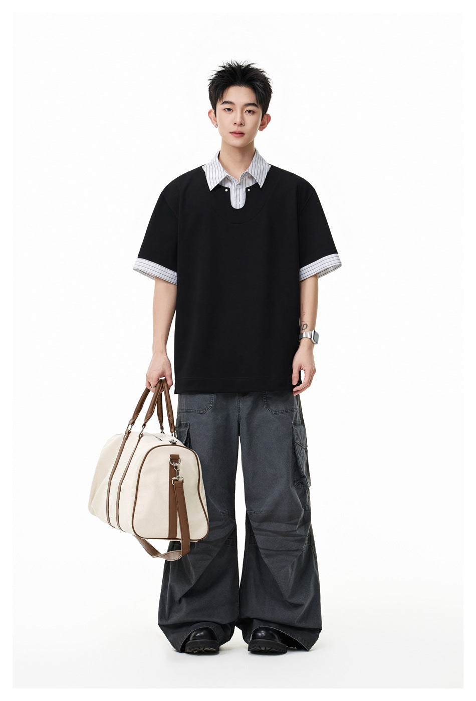 Model wearing an oversized black short-sleeve top with a striped shirt collar and cuffs, plus charcoal cargo pants.