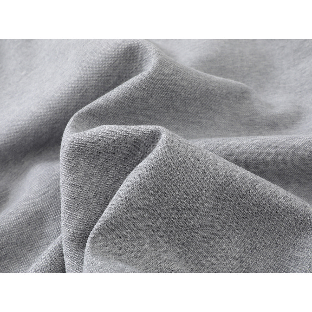 Close-up of the light gray jacket's textured-looking fabric draped into soft folds.