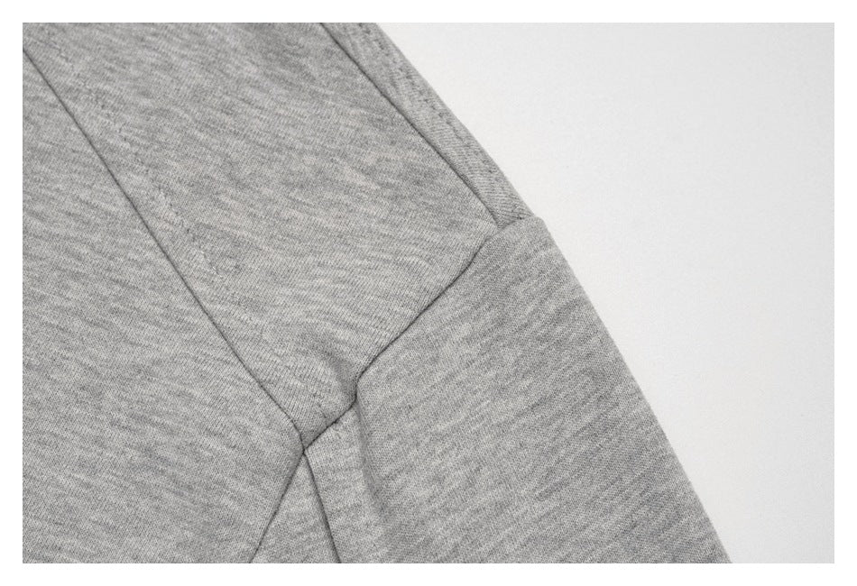 Close-up of the heather-gray garment's sleeve and shoulder seam.