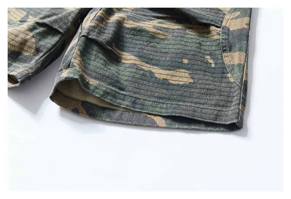 Close-up of a camouflage short leg hem with visible stitching.