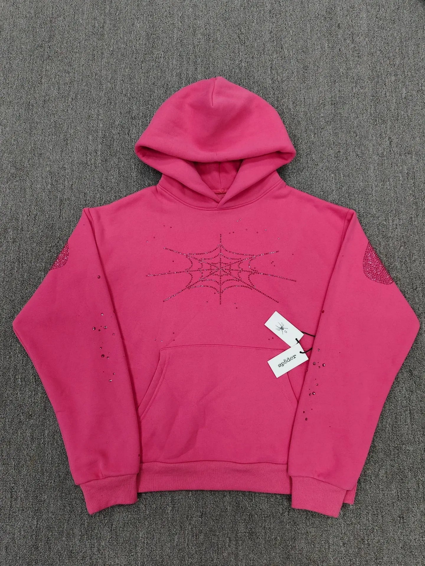 Pink Sp5der hoodie with rhinestone spider web graphic on chest and crystal accents on sleeves