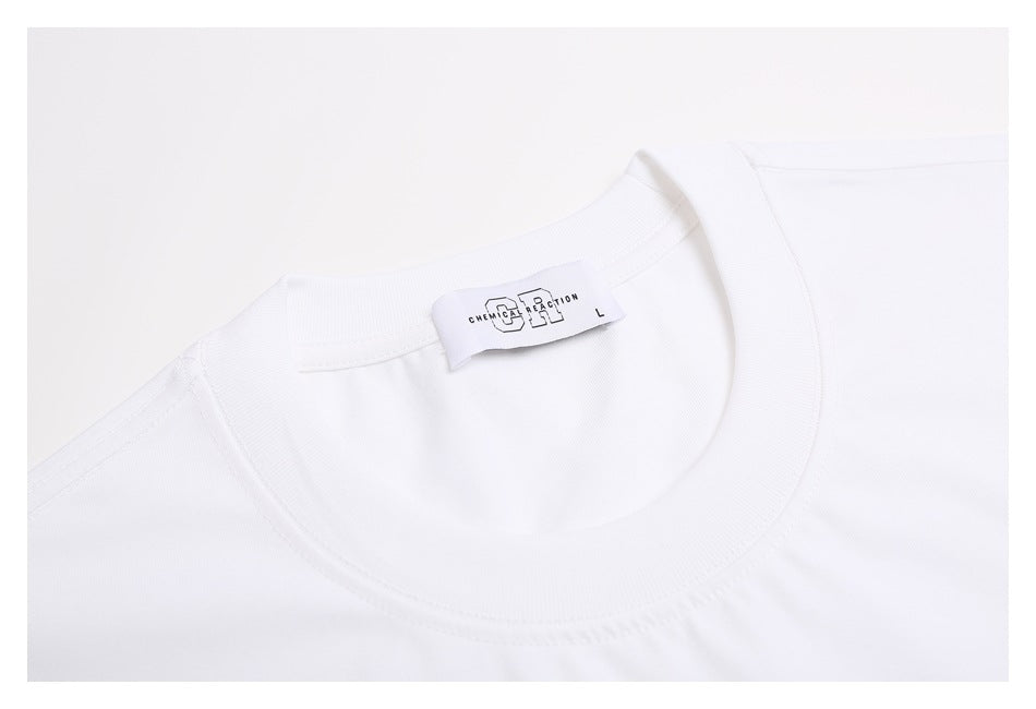 Close-up of the white T-shirt's ribbed crew neckline and inner label.