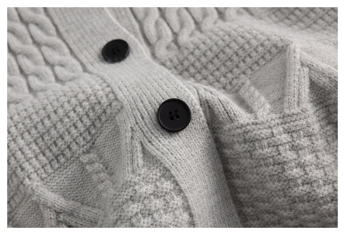 Close-up of black buttons, knit placket, and contrasting textured sections on a light gray cardigan.