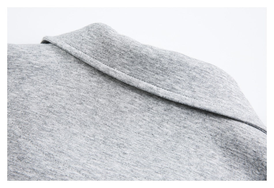 Close-up of a folded collar on a gray heather knit garment.